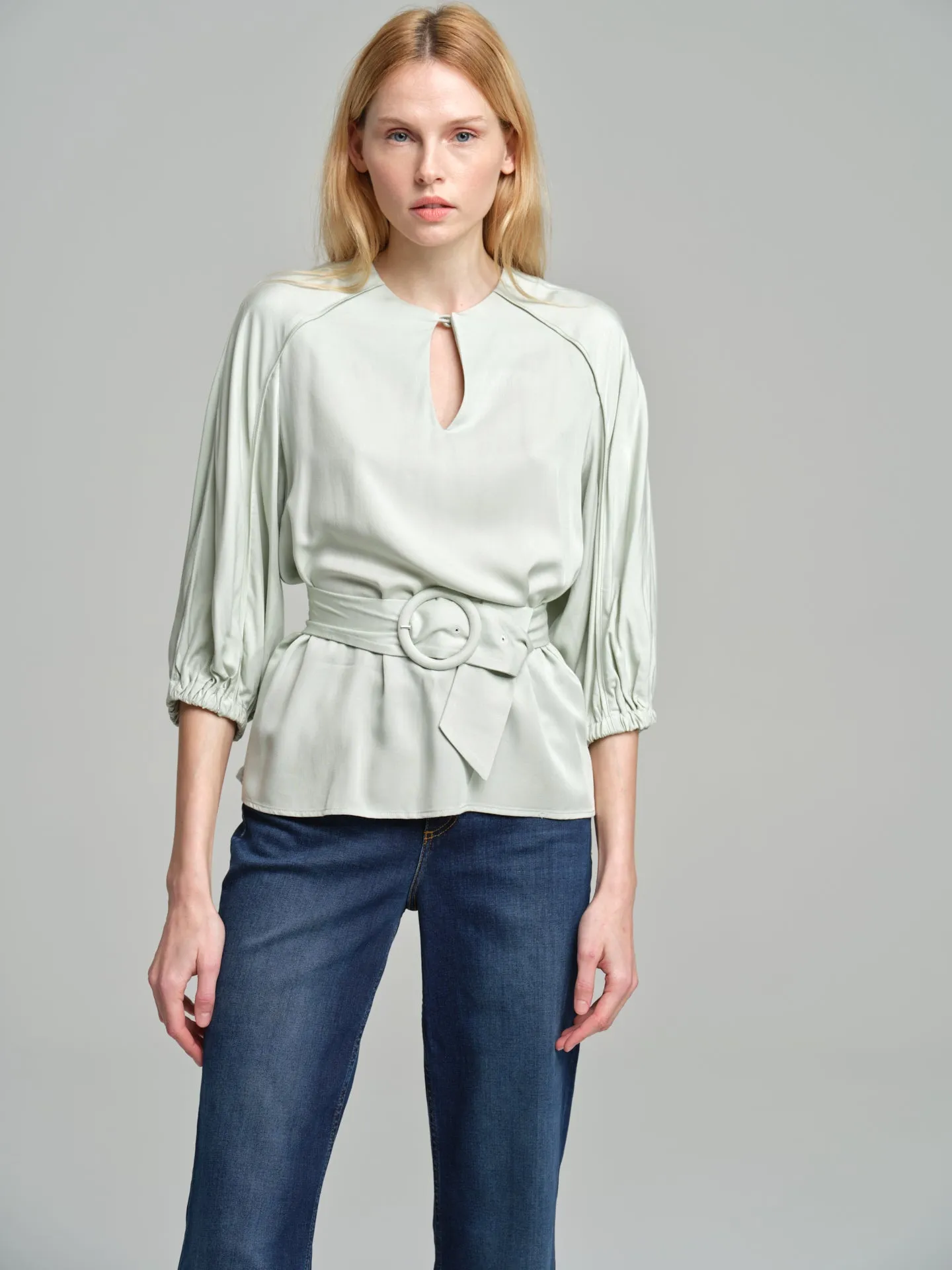 Fancy belted blouse with tear drop neckline