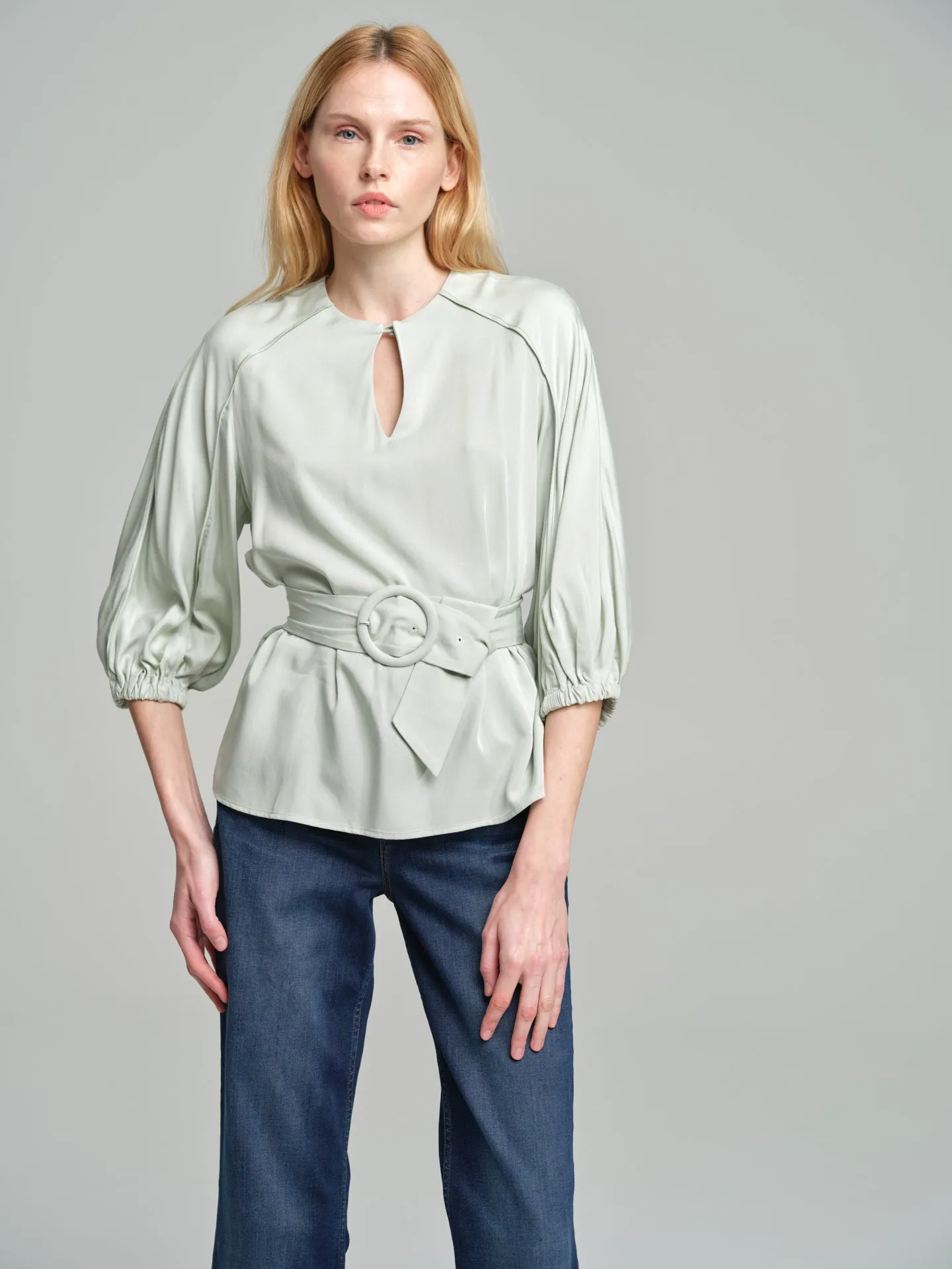 Fancy belted blouse with tear drop neckline