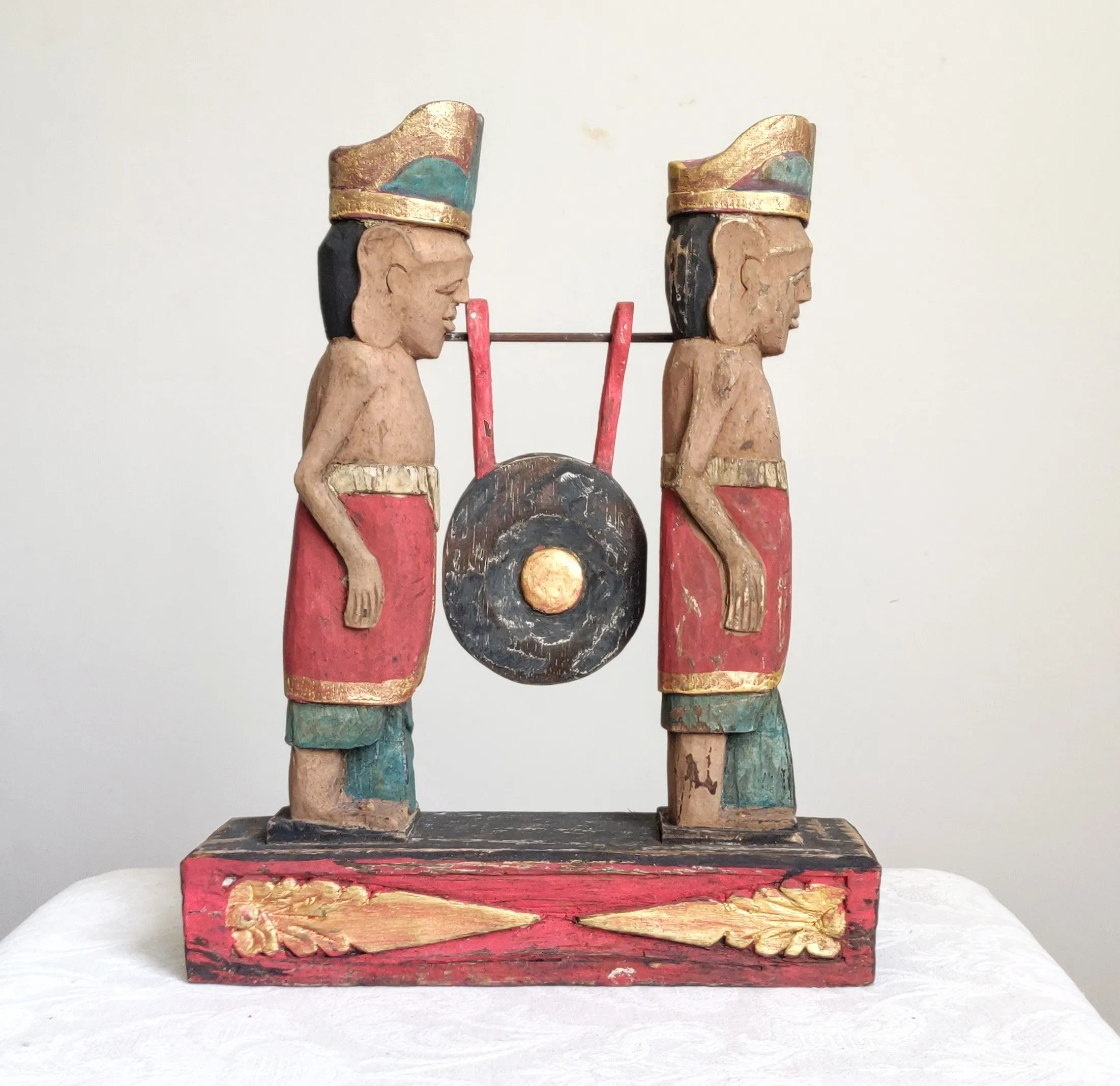 Home Decor. Tabletop Sculpture.
Hand Carved and Painted Pair of Solid Wooden Figures on a Floral Pedestal - Melasti, a Hindu Ceremony.