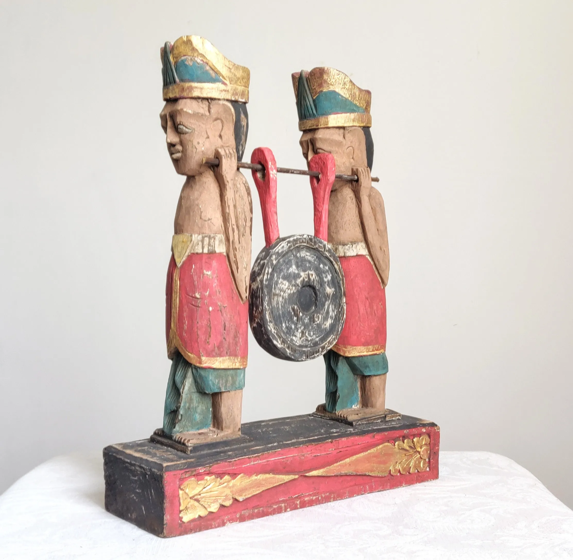 Home Decor. Tabletop Sculpture.
Hand Carved and Painted Pair of Solid Wooden Figures on a Floral Pedestal - Melasti, a Hindu Ceremony.
