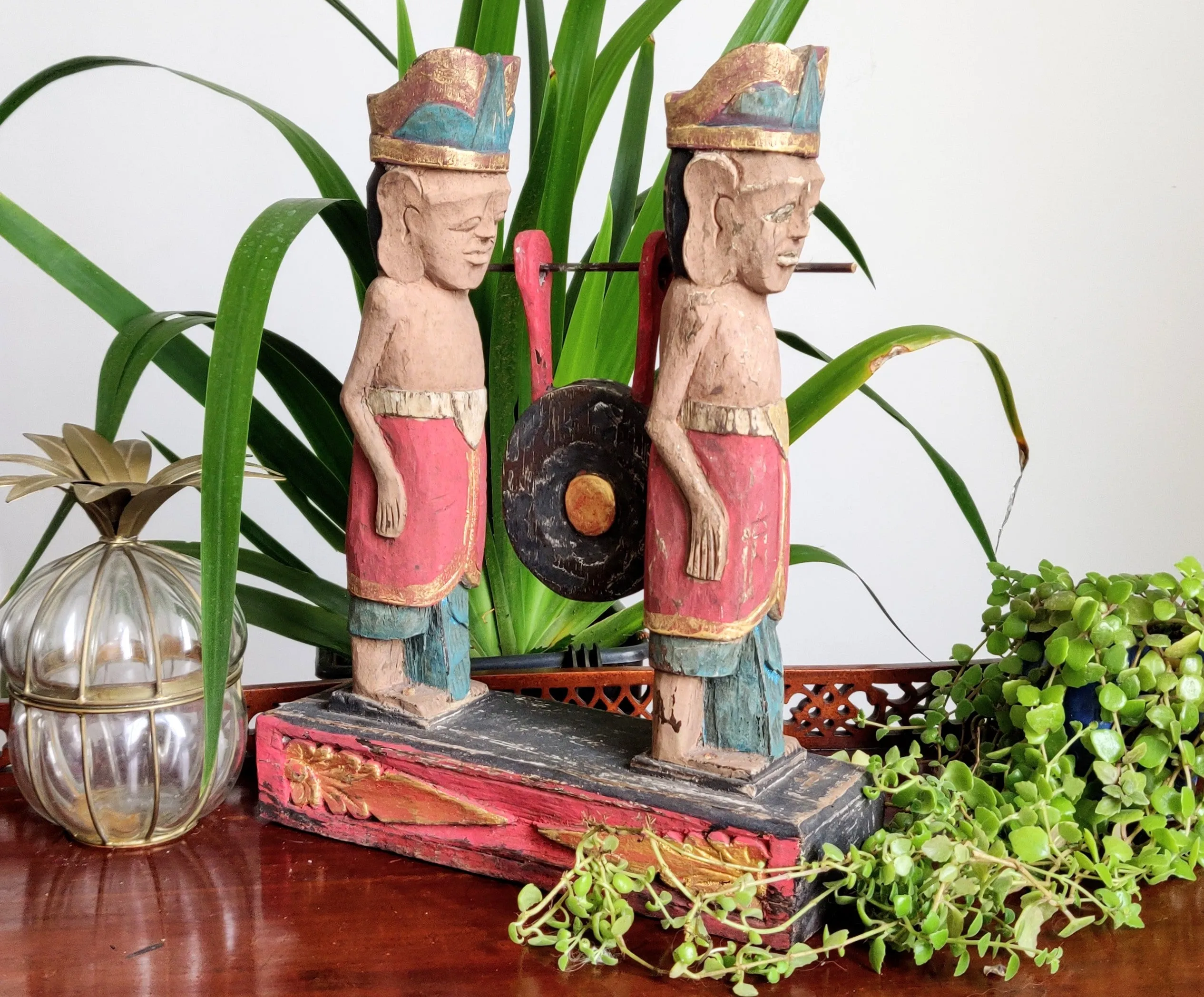 Home Decor. Tabletop Sculpture.
Hand Carved and Painted Pair of Solid Wooden Figures on a Floral Pedestal - Melasti, a Hindu Ceremony.